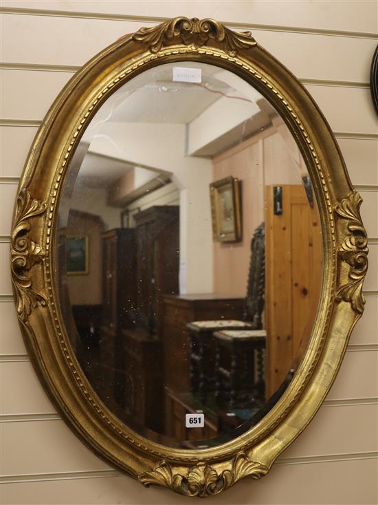 A gilt frame oval wall mirror, H.82cm